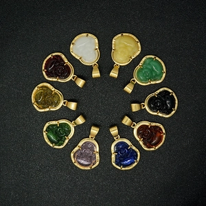 Mini 18k gold stainless steel Buddha pendants set in multiple glass colors on black background