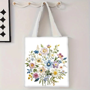 Détail du sac cabas en toile fleurie montrant le tissu dense et la broderie colorée