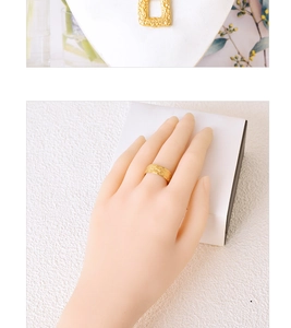 Detail of golden hammered texture square pendant and open ring set for women