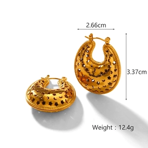 Detailed view of gold cutout star and moon earrings with dimensions 2.66cm by 3.37cm