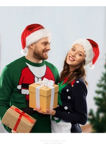Cheerful couple wearing festive LED Santa hats and holiday sweaters in cozy setting