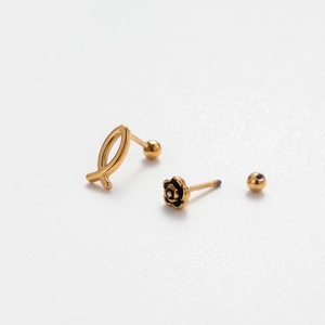 Detail of gold ribbon and black rose cartilage studs with threaded screw back posts