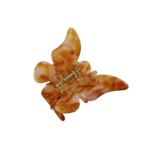 Elegant butterfly hair claw clip with amber tortoiseshell texture on white background