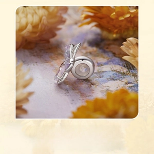 Macro view of sterling silver flower bead with faceted purple opal and fine details