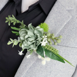 Elegant grey-green silk rose boutonniere for weddings with foliage and berry accents
