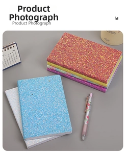 Detailed top view of assorted colorful sequin notebooks and sparkling stationery set