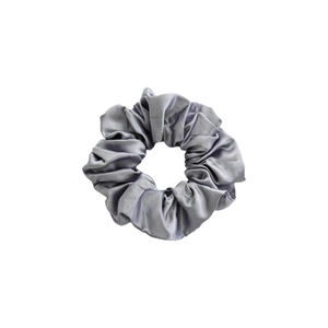 Grey silk satin scrunchie with elegant pleats isolated on white background