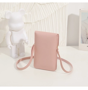 Chic dusty pink faux leather mini shoulder bag on elegant white fabric background