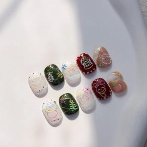 Christmas themed embossed press-on nails featuring gingerbread man and Santa designs