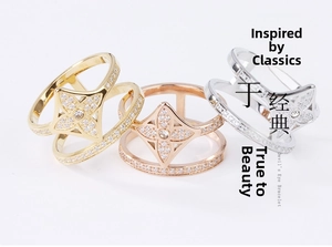 Detailed view of three layered flower rings with sparkling cubic zirconia in gold and silver