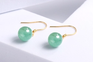 Detailed close-up of green aventurine bead earrings with elegant golden hooks on a white base