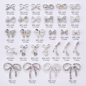 Macro detail of various alloy bowknot nail art charms with pearls and rhinestones