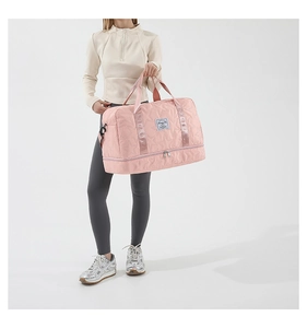 Pink quilted star fitness bag featuring a dedicated bottom compartment for shoes and gear