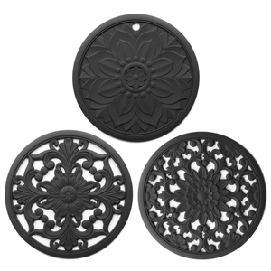 Three black heat-resistant silicone table mats with various hollow Chinese floral patterns