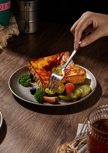 Macro view of vintage 304 stainless steel platter and ergonomic curved dining fork