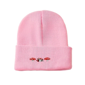 Pink knitted beanie with three mushroom embroidery features a warm ribbed design