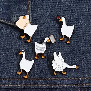 Set of 5 funny white goose enamel pins on denim, featuring bread and rose accessories
