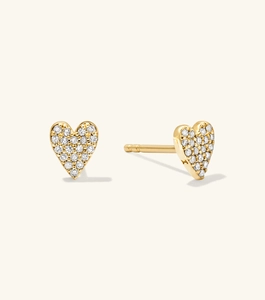 Detailed macro view of heart shaped gold stud earrings with pavé set sparkling crystals