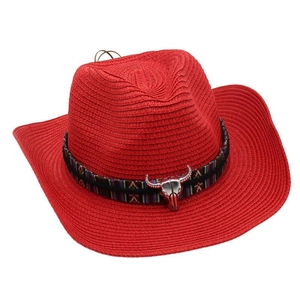 Detail view of woven straw cowboy hat featuring metal bull skull ornament and vintage jacquard band