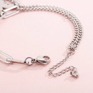 Detailed view of silver stainless steel mixed chain bracelet with lobster clasp and charm