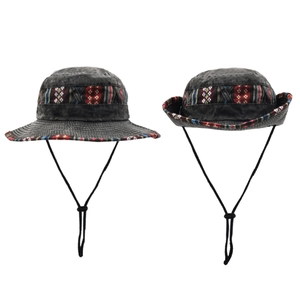 Detail of dark gray cotton bucket hat with colorful ethnic pattern trim and windproof cord