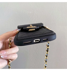 Close-up of black quilted mini bag and metal chain detail on silicone phone case
