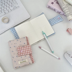Floral and plaid fabric notebook covers with button closure in pink and blue styles