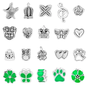 Detailed view of twenty silver and green enamel ocean-themed charms and beads