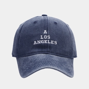 Detailed embroidery of white A LOS ANGELES letters on a navy washed cotton baseball cap