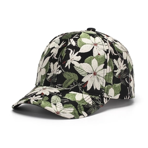 Detailed view of floral pattern embroidery on a black baseball cap with white blossoms