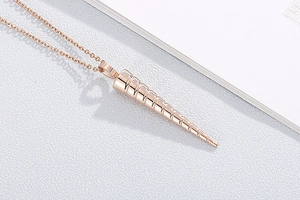 Detailed close-up of a rose gold conical pendant on a delicate O-chain necklace