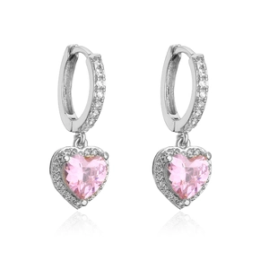 Macro detail of silver heart earrings with pink stones and pavé set crystals