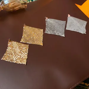 Geometric triangle mesh tassel earrings in gold and silver finish on leather base