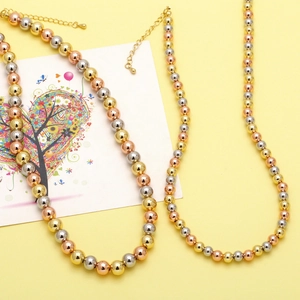 Detailed shot of tri-color metal beaded necklace with lobster clasp and adjustable chain