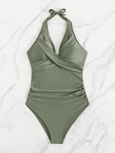 Detail of olive green halter one-piece swimsuit with cross-twist front and ruched waist
