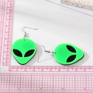 Close-up of neon green acrylic alien earrings with size ruler showing 4cm length