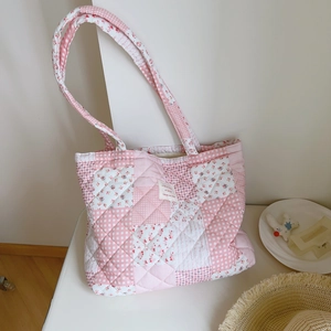 Detailed close-up of pink floral quilted cotton tote bag featuring patchwork patterns