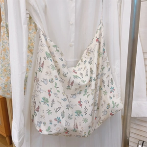 Detailed texture of cotton tote bag with floral and animal prints on white shirt