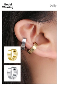 Close-up of minimalist gold and silver stainless steel hoop earrings worn on ear