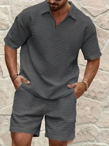 Detailed waffle texture of dark grey men's zipper polo shirt and casual shorts set