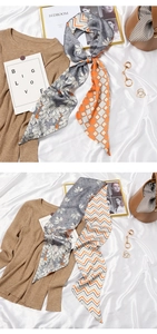 Detail of vintage French silk scarf with floral and geometric patterns on soft fabric