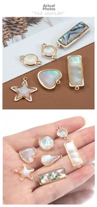 Detailed view of iridescent natural shell charms with gold plating for DIY jewelry making