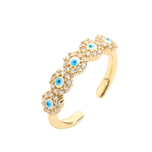 Macro detail of gold adjustable ring featuring five micro-pave zircon evil eye charms