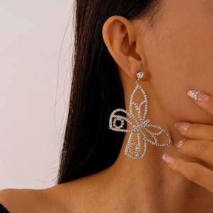 Close-up of sparkling butterfly earrings with rhinestones on model's ear