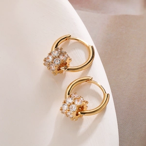 Close-up of gold-plated hoop earrings with micro-paved white zircon beads detail