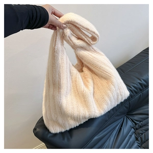 Detailed view of plush faux rabbit fur tote bag in creamy beige with soft texture