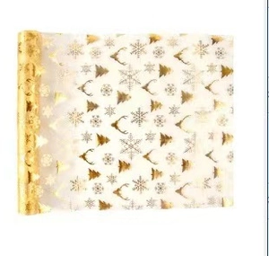 Close-up of beige polyester mesh table runner with gold Christmas foil patterns