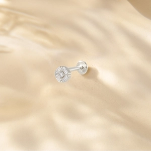 Macro shot of silver S925 engraved hexagon cartilage stud earring with cubic zirconia