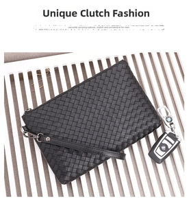 Detail of black woven leather texture and metal zipper on men's large clutch bag