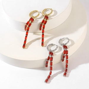 Detail of 18K gold and silver long tassel earrings with red rectangular zircon stones